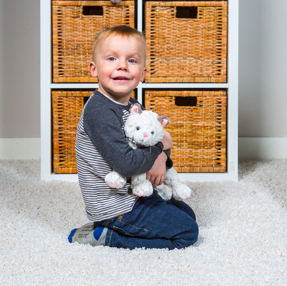 Child snuggles with Mary Meyer Patches Putty Kitty