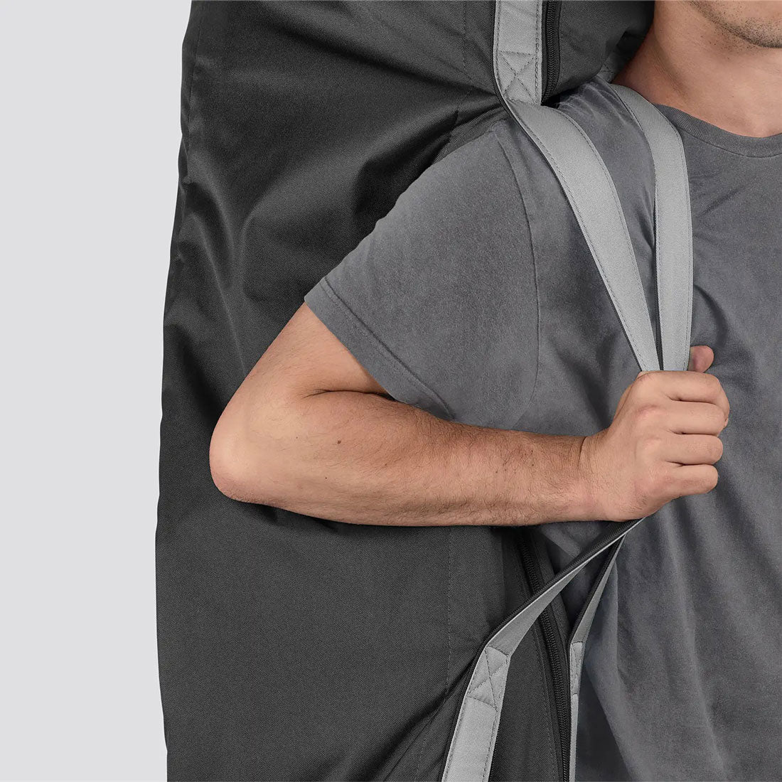 Man carrying stroller in UPPAbaby G-LUXE / G-LITE TravelSafe Travel Bag