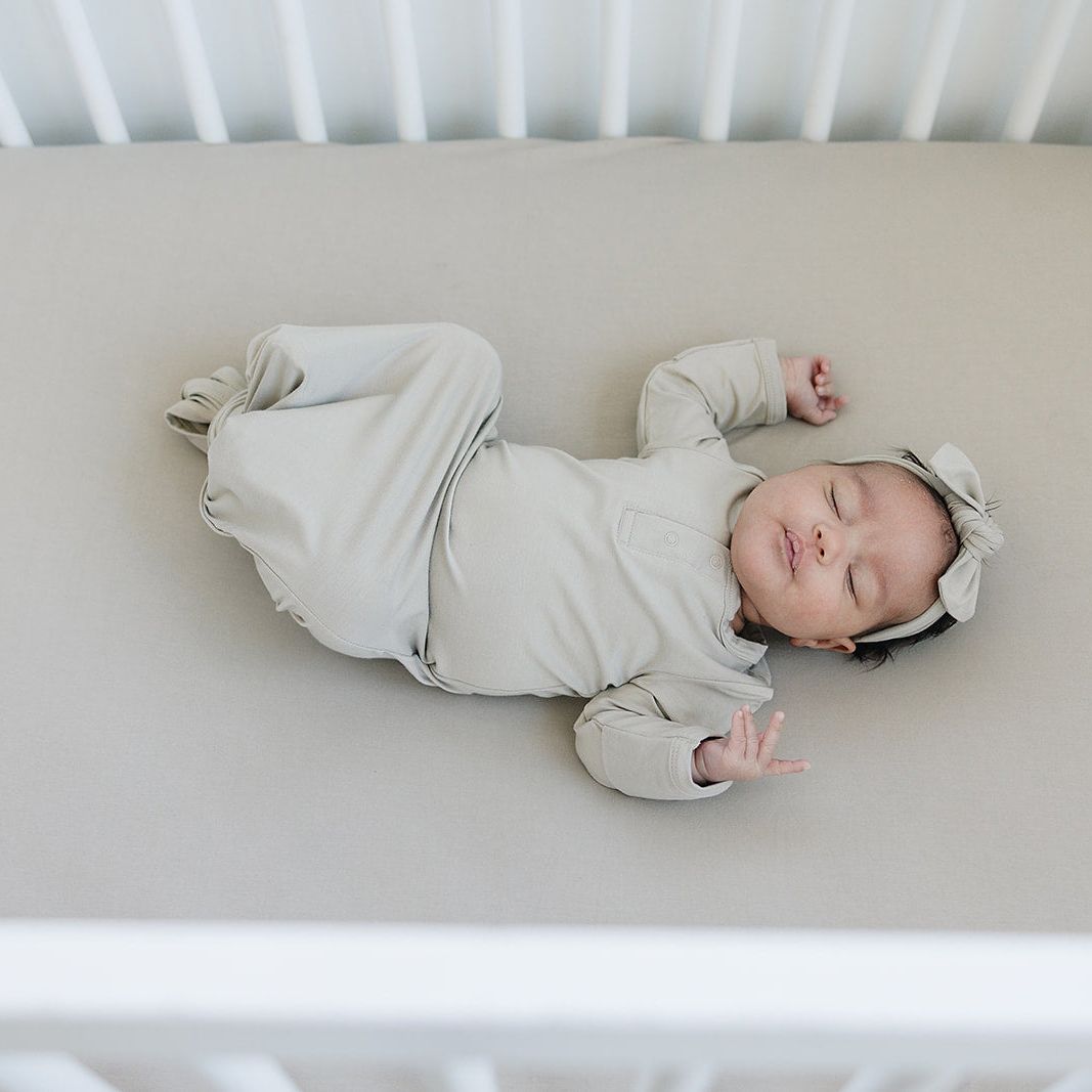 Baby sleeping on Mebie Baby Bamboo Stretch Crib Sheet - Oatmeal