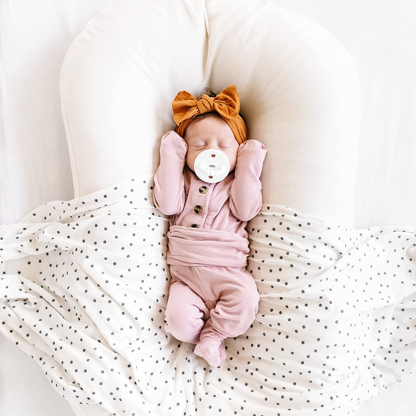 Newborn sleeping while sucking on Ryan and Rose Cutie PAT Kit - Neutral Kit