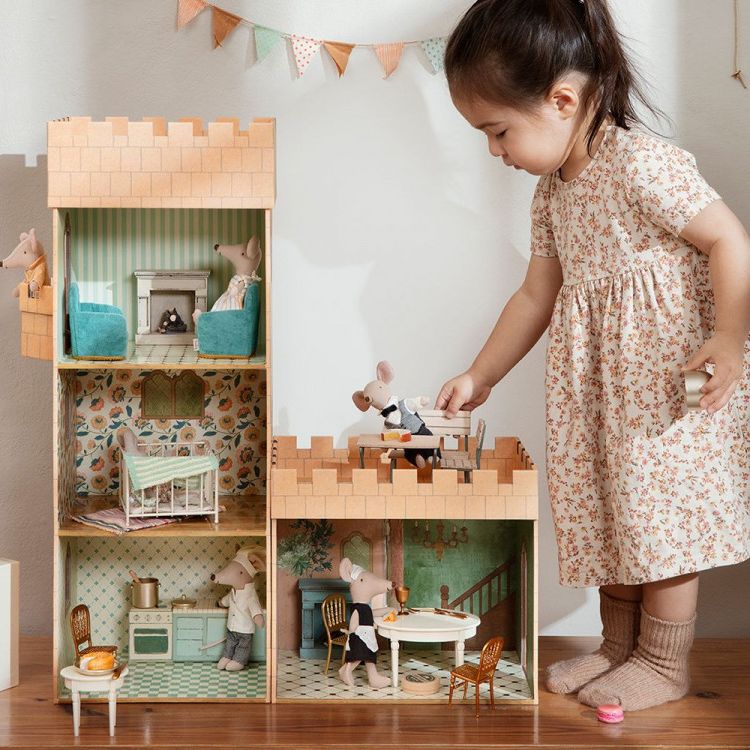 child playing with Maileg Cheese Bell inside dollhouse