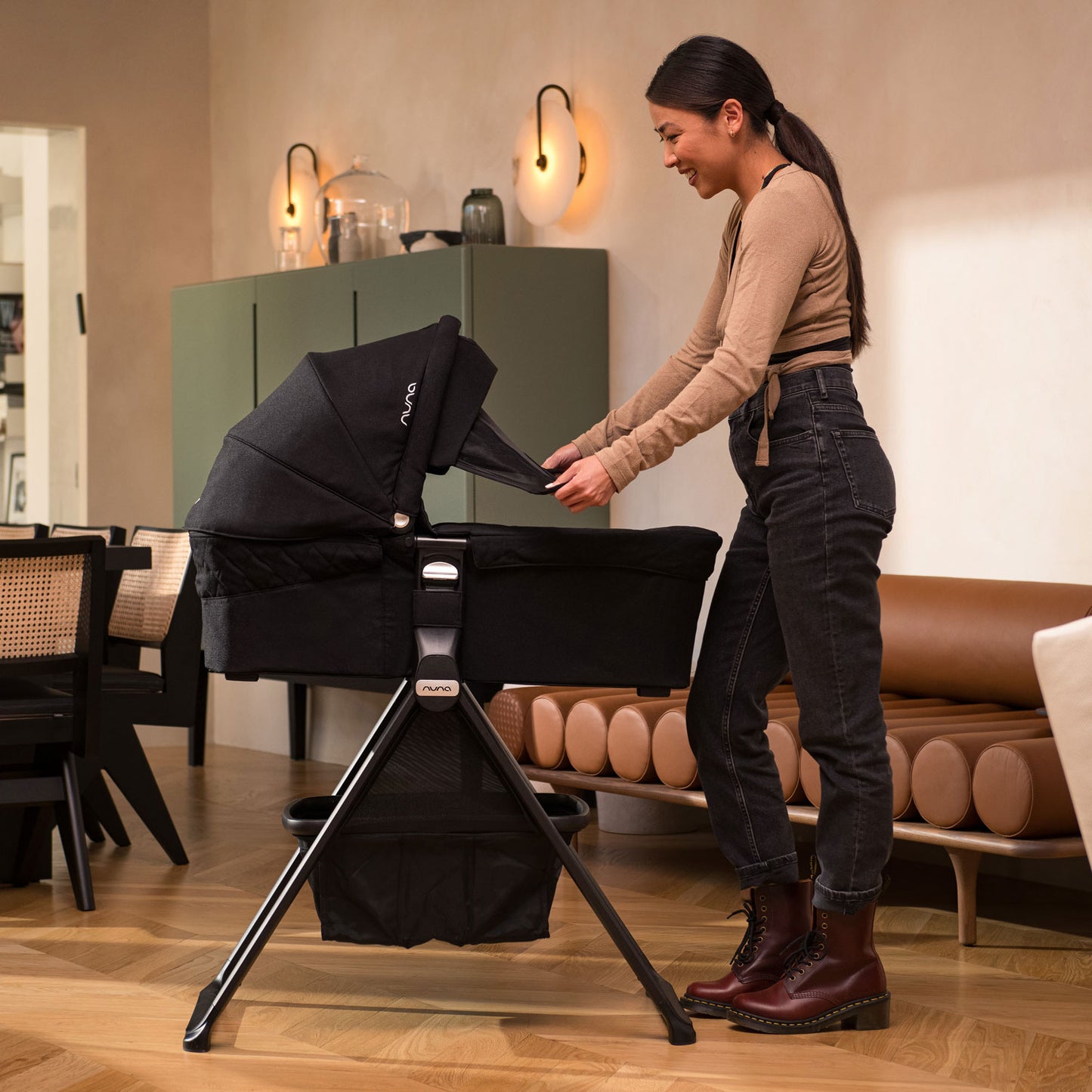 Mom using Nuna MIXX Series Bassinet + Stand - Caviar