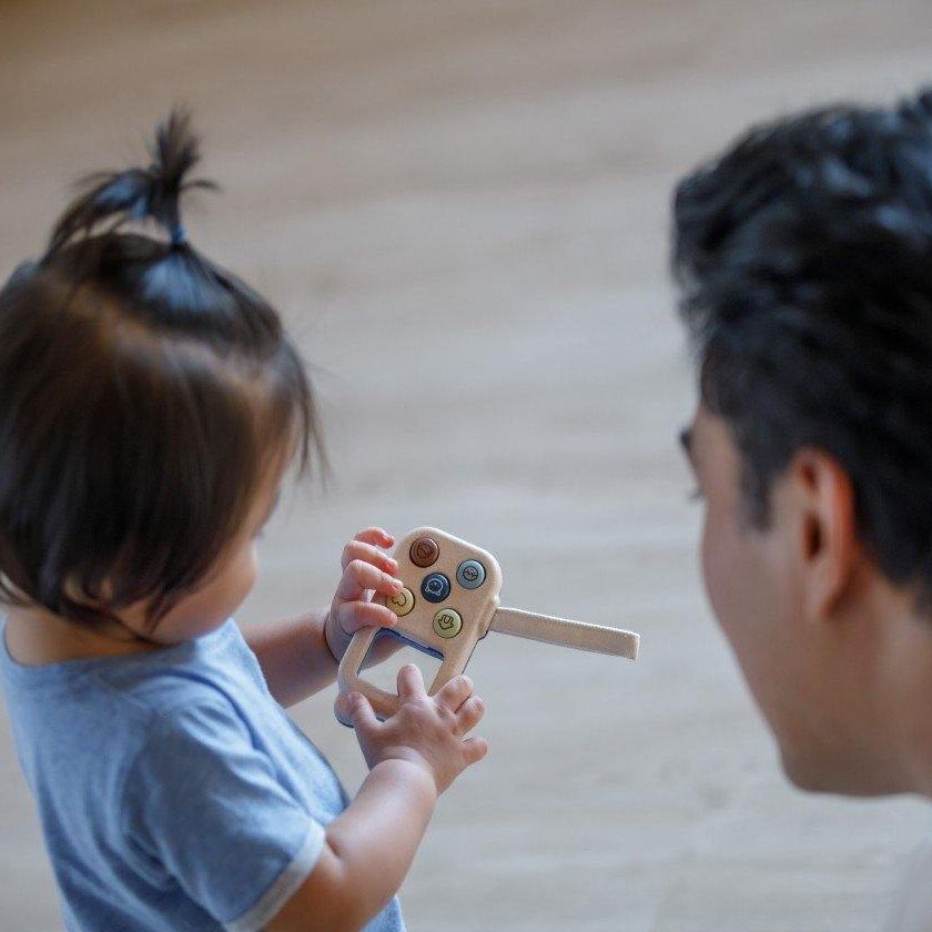 Toddler Playing with PlanToys My First Phone - Orchard Series