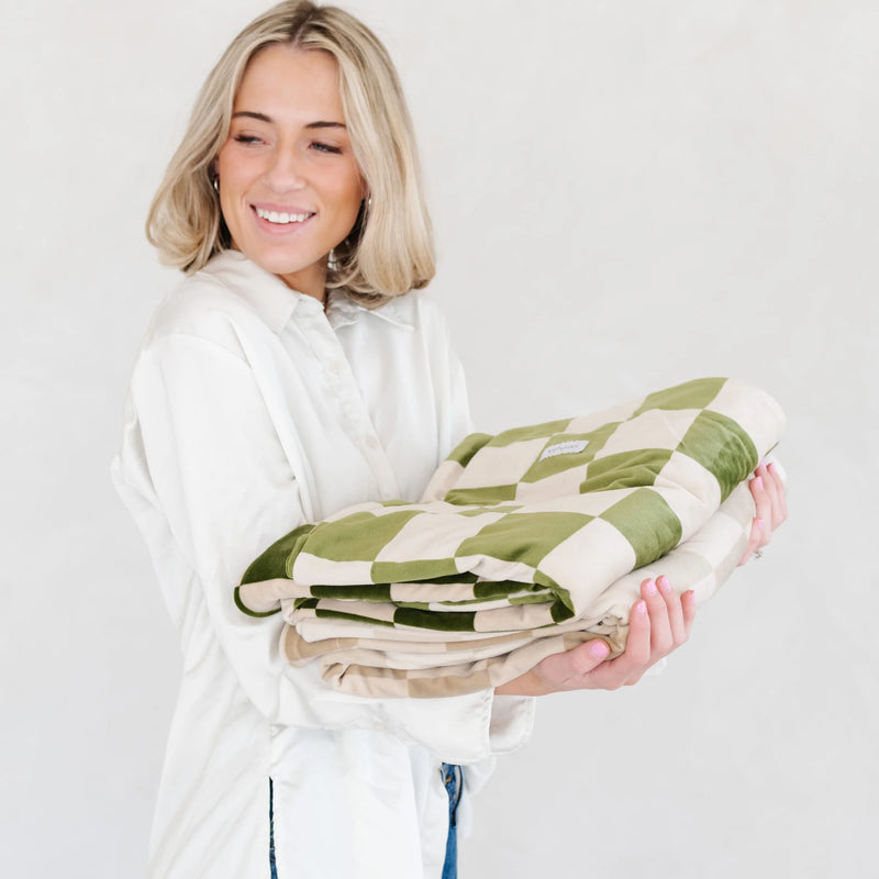 Woman Carrying Saranoni Receiving Minky Stretch Blanket 