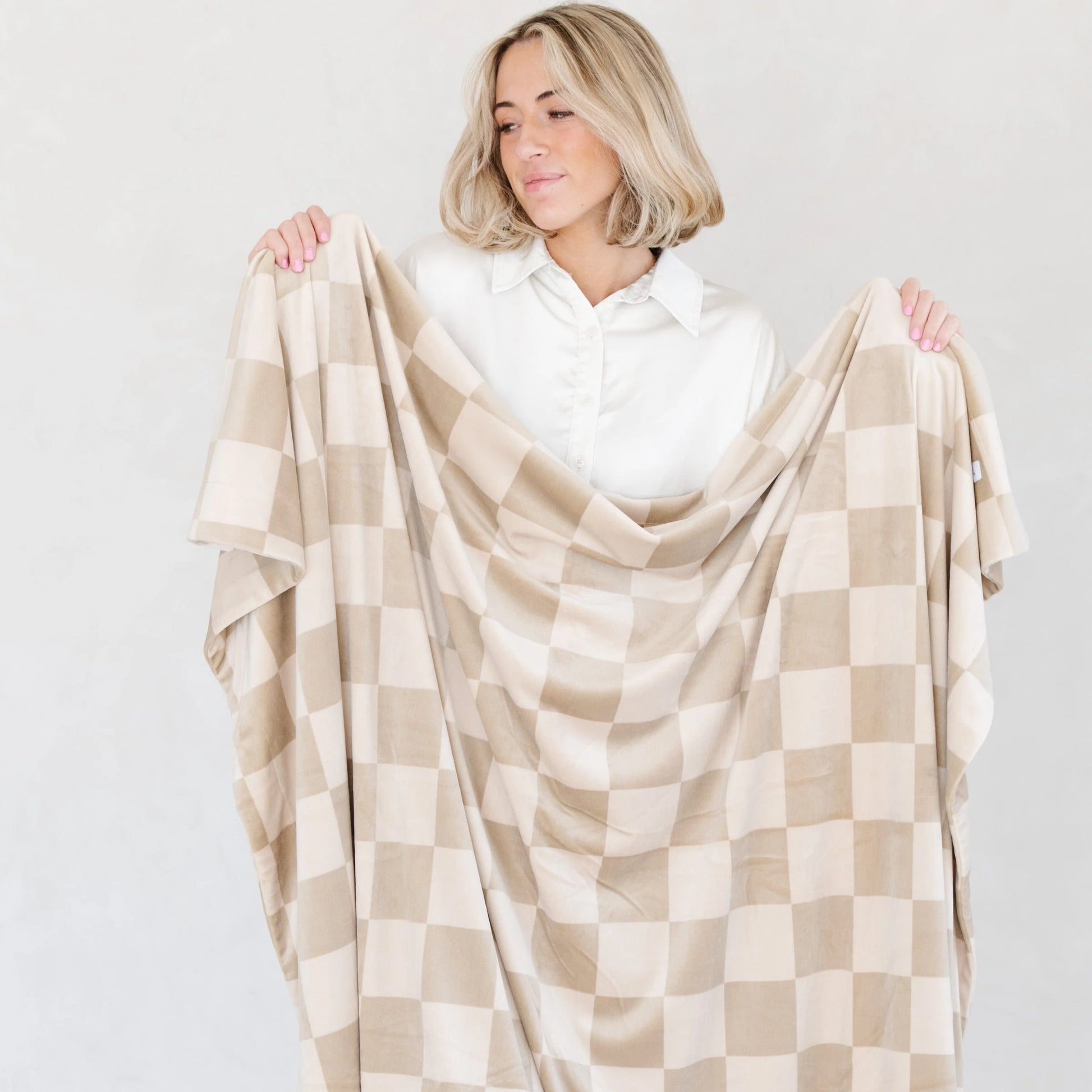 Woman Holding Saranoni Minky Stretch XL Throw Blanket - Neutral Checkered