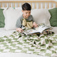 Boy Reading with Saranoni Receiving Minky Stretch Blanket - Olive Checkered