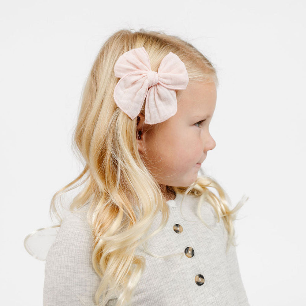 Little girl wearing Lou Lou and Company Cloud Muslin Heirloom Bow Clip - Blush