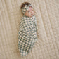 Baby wrapped in Mebie Baby Bamboo Stretch Swaddle Blanket - Light Green Checkered