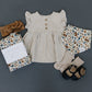 Little girl wearing Mebie Baby Ruffle Linen Dress - Taupe Gingham