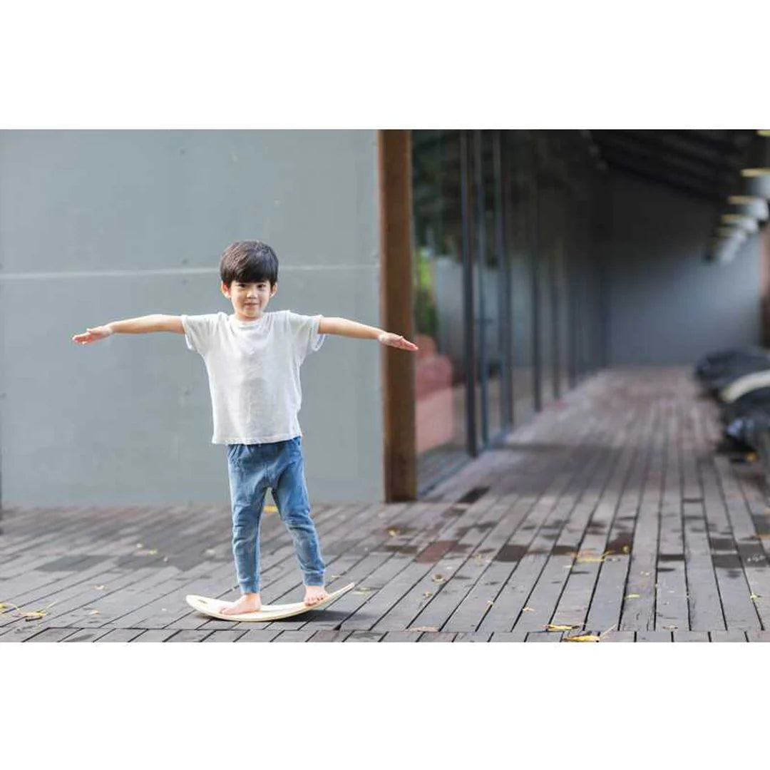 Little boy riding PlanToys Balance Board