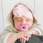 Baby using RaZbaby Jollypop Pacifier - Pink