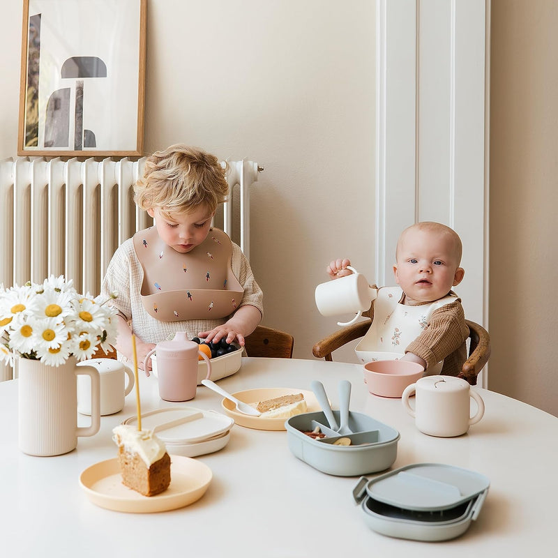 Toddler and baby wear Mushie Silicone Bibs at mealtime