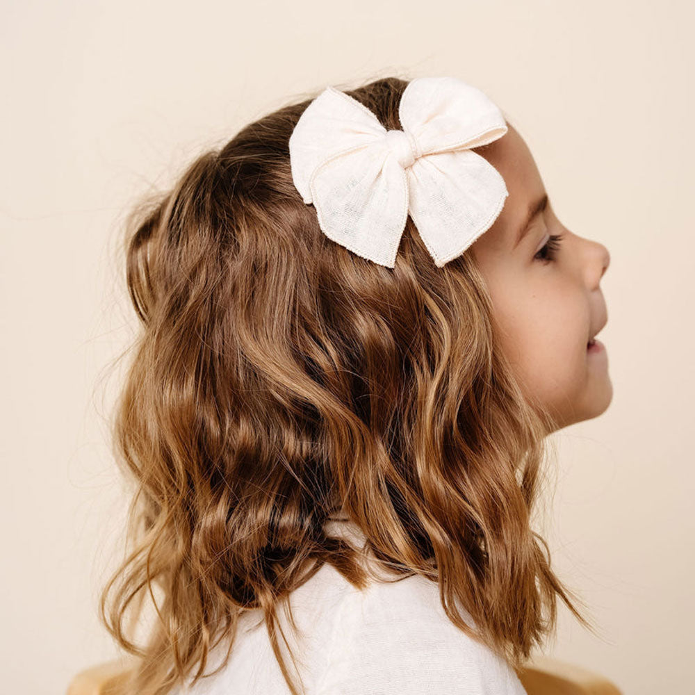Little girl wearing Lou Lou and Company Cloud Muslin Heirloom Bow Clip - Cream