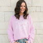 Woman wearing The Baby Cubby Crewneck Sweatshirt - Cubby Mama - Light Pink