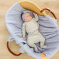 Baby lying on Copper Pearl Rib Knit Swaddle Blanket - Periwinkle