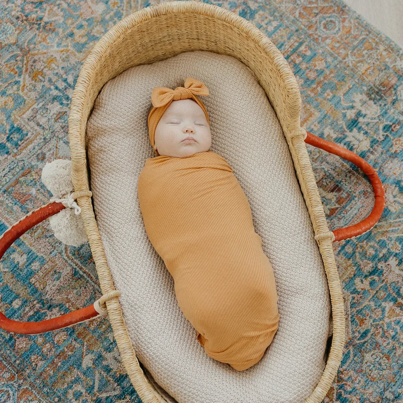 Baby wrapped in Copper Pearl Rib Knit Swaddle Blanket - Dolce