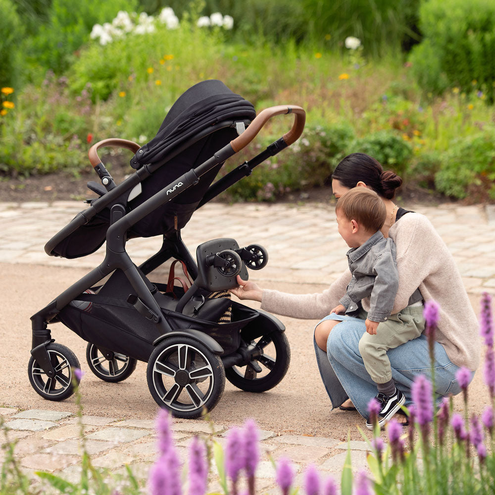 Mother and child with Nuna DEMI Next Stroller with Rider Board