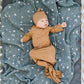 Baby laying on Mebie Baby Muslin Swaddle Blanket - Night Sky