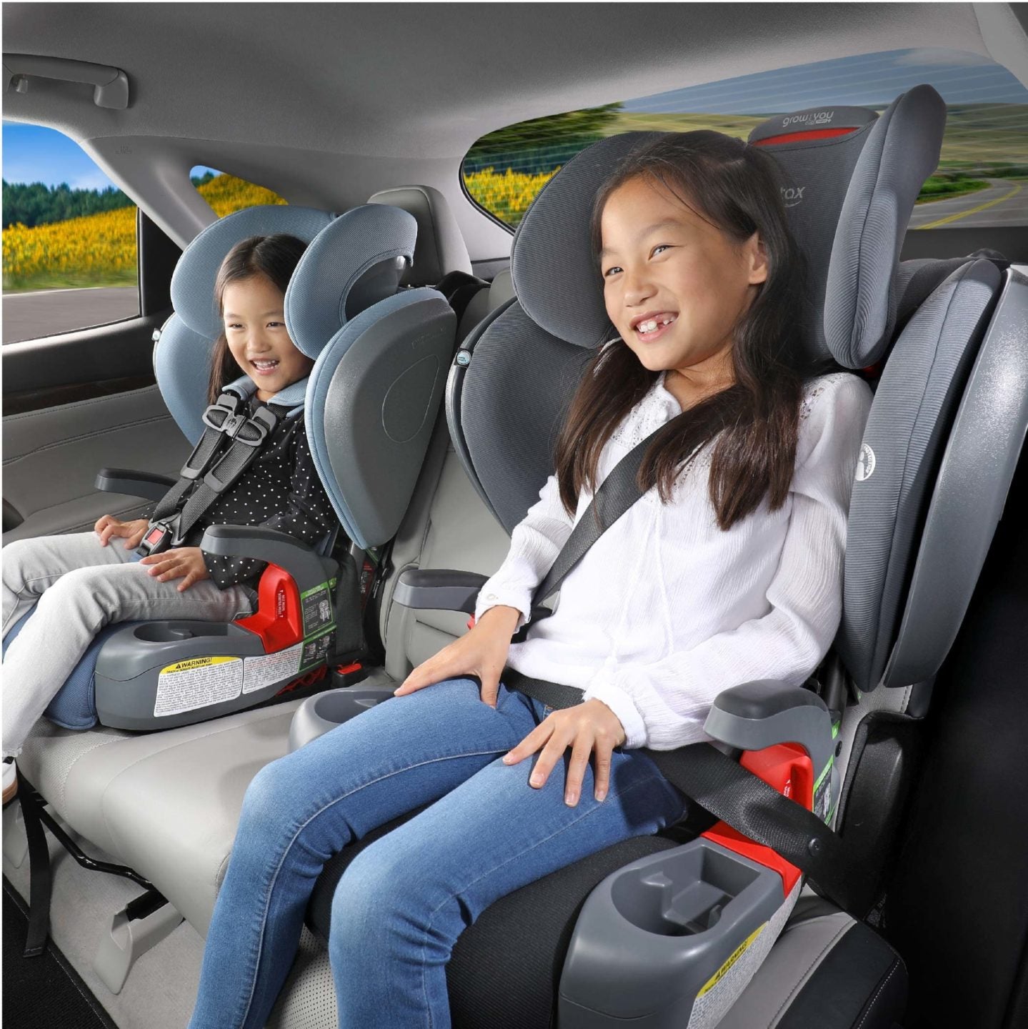 Two children in back of car in two Britax Grow With You ClickTight Harness-2-Booster Seats