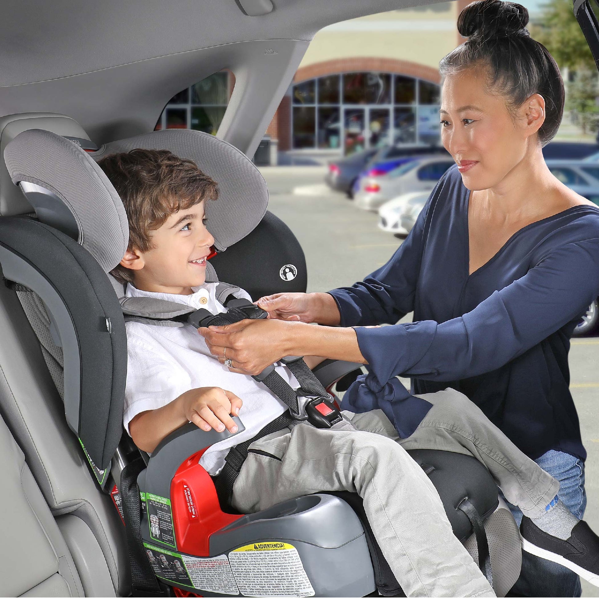 Mom buckles son into Britax Grow With You Harness-2-Booster Seat - Mod Black Safewash