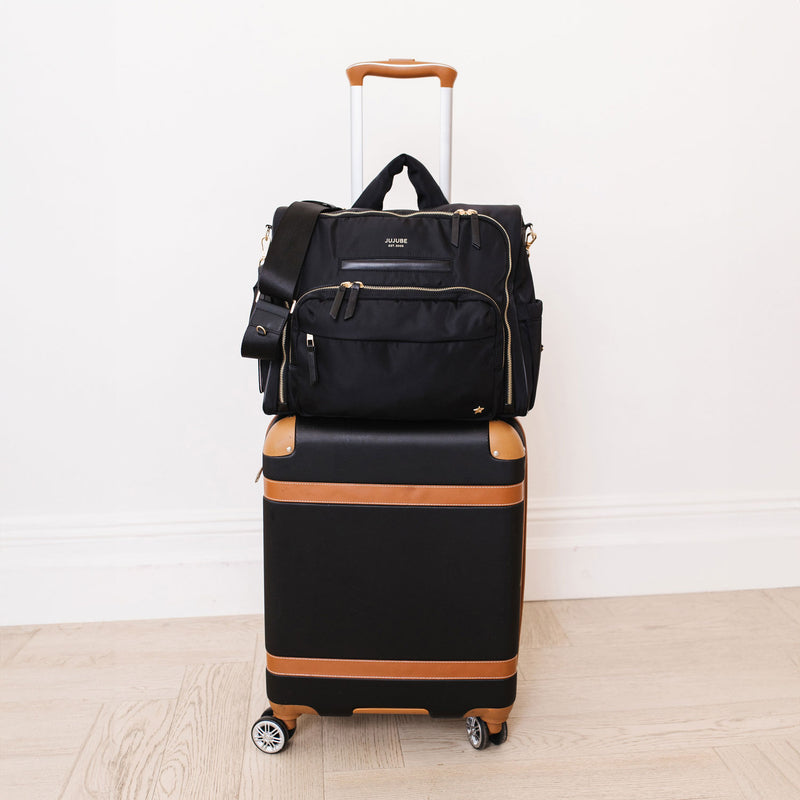 JuJuBe Satchel - Black on a suitcase