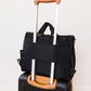 JuJuBe Satchel - Black on a suitcase