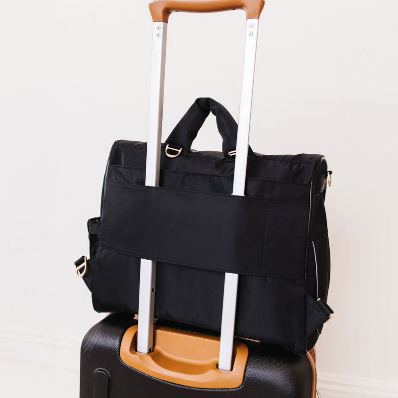 JuJuBe Satchel - Black on a suitcase