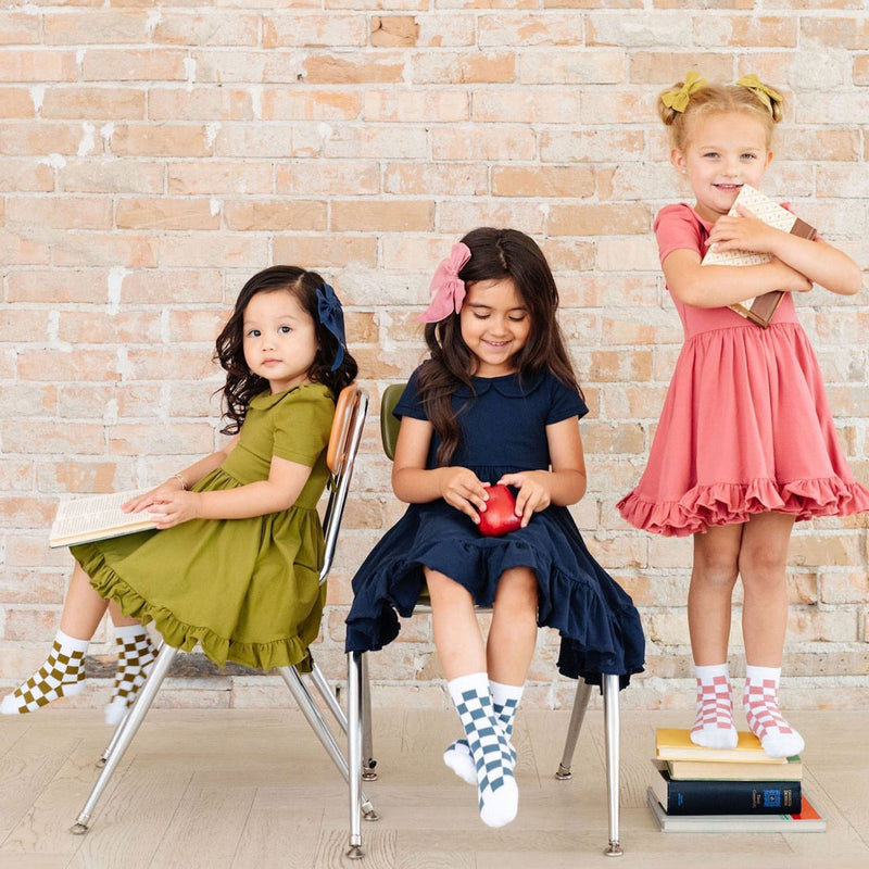 Three little girls wearing Little Stocking Co Midi Sock 3-Pack - Hopscotch