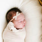 Baby wearing Lou Lou and Company Lace Bow Headband - Mini - Cream