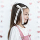 Little girl wearing Modern Piggy Seasonal Statement Ribbon Bow - Alligator Clip - Romantic