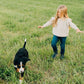 Little girl playing with dog while wearing Mebie Baby Knit Ruffle Sweater - Oatmeal