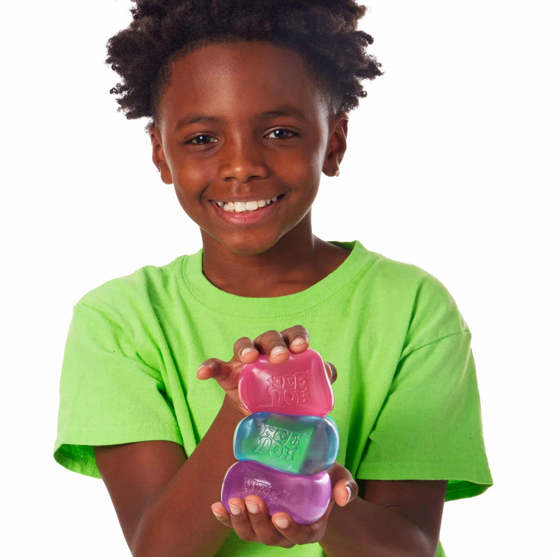 Child holding Schylling NeeDoh Nice Cube