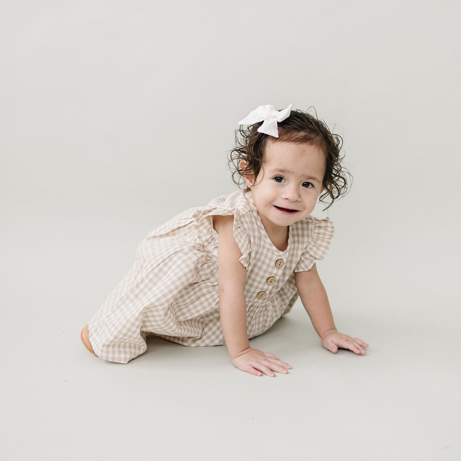 Little girl wearing Mebie Baby Ruffle Linen Dress - Taupe Gingham