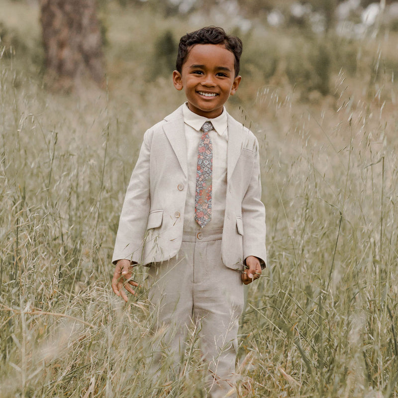 Boy standing in field wearing Noralee Skinny Tie - Berry Garden