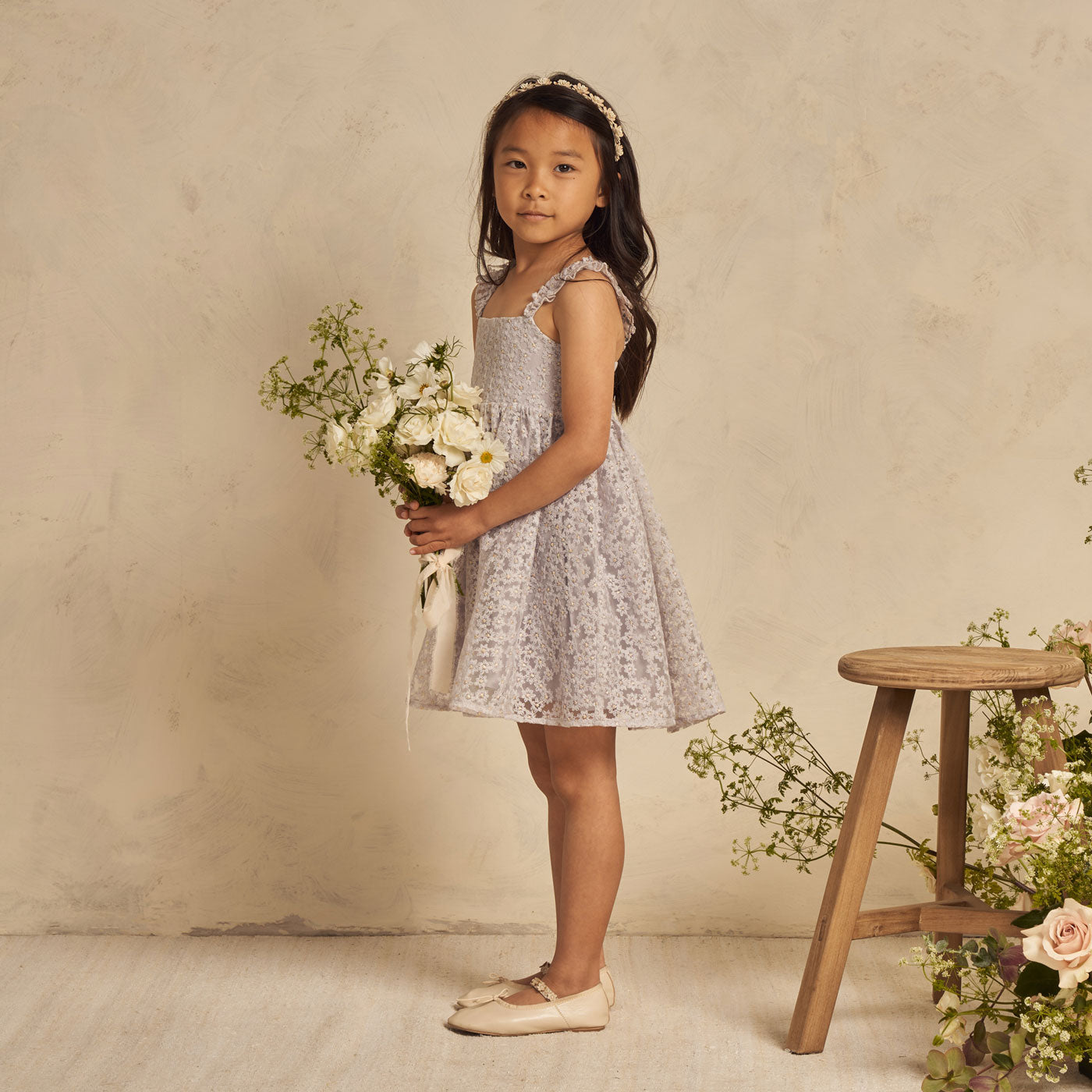 Girl holds flowers while wearing Noralee Mara Dress - Cloud Daisy Tulle