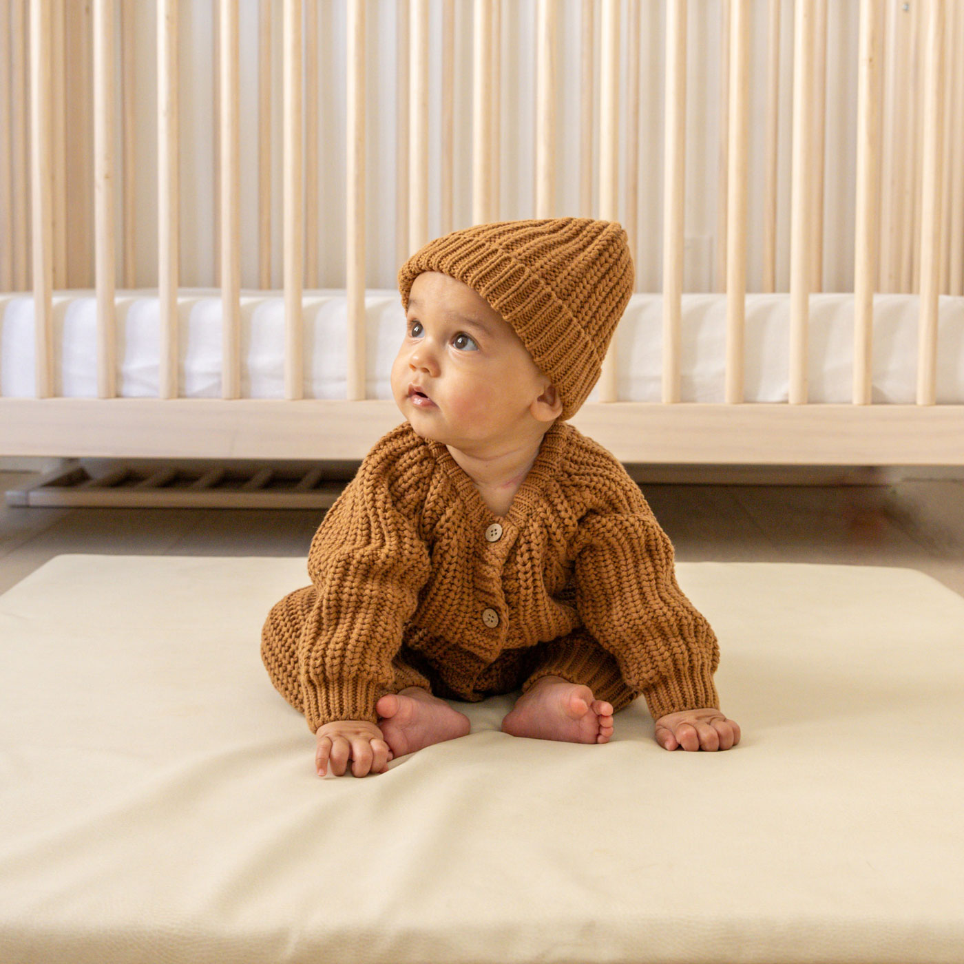 Baby wearing Quincy Mae Chunky Knit Jumpsuit - Cinnamon