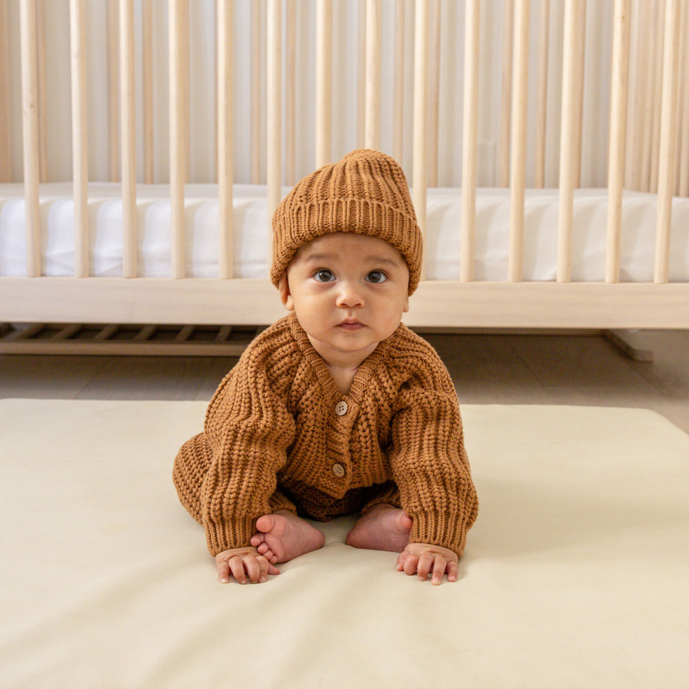 Baby wearing Quincy Mae Chunky Knit Jumpsuit - Cinnamon