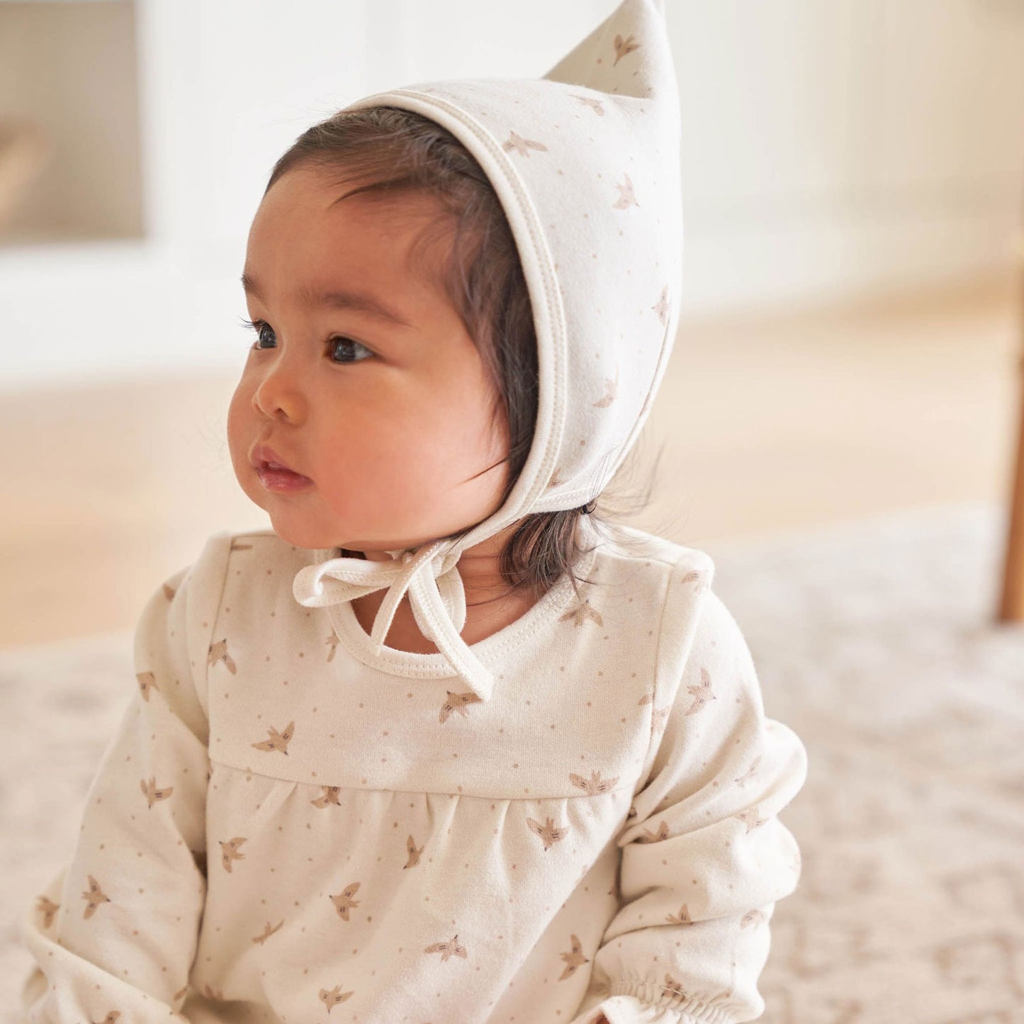 Little girl wearing Quincy Mae Pixie Bonnet - Doves - Ivory