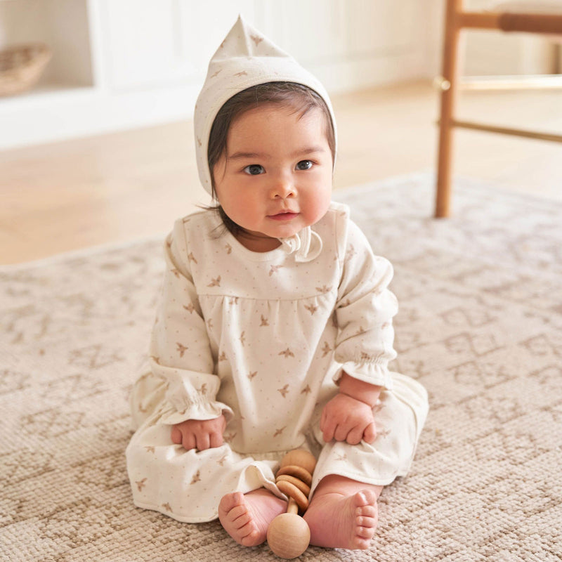 Little girl wearing Quincy Mae Pixie Bonnet - Doves - Ivory