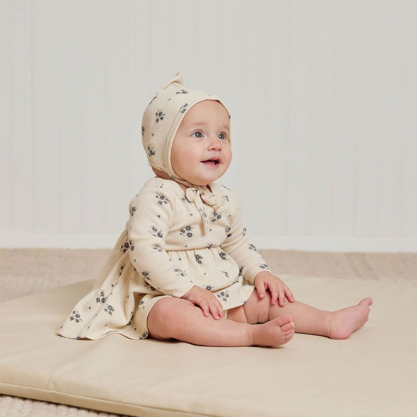 Baby wearing Quincy Mae Ribbed Long Sleeve Dress - Navy Ditsy - Natural