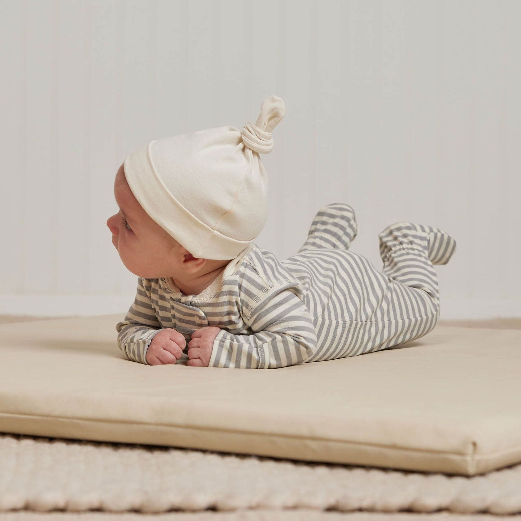 Baby wearing Quincy Mae Zip Long Sleeve Sleeper Footie - Dusty Blue Stripe