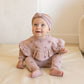 Baby wearing Quincy Mae Fleece Sweatpant - Snow Stars - Mauve