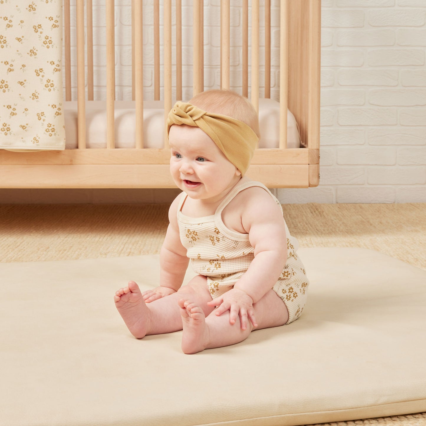 Baby wearing Quincy Mae Waffle Cinch Romper - Honey Flower - Natural 