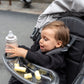 child in stroller with UPPAbaby RIDGE Snack Tray
