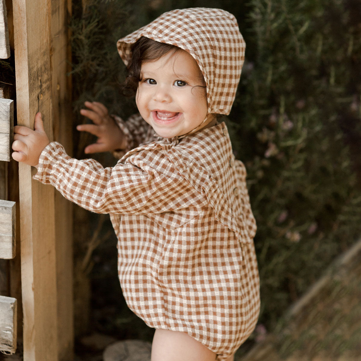 Toddler girl wearing Rylee and Cru Winnie Romper - Brown Gingham