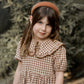 Girl wearing Rylee and Cru Camille Dress - Brown Gingham