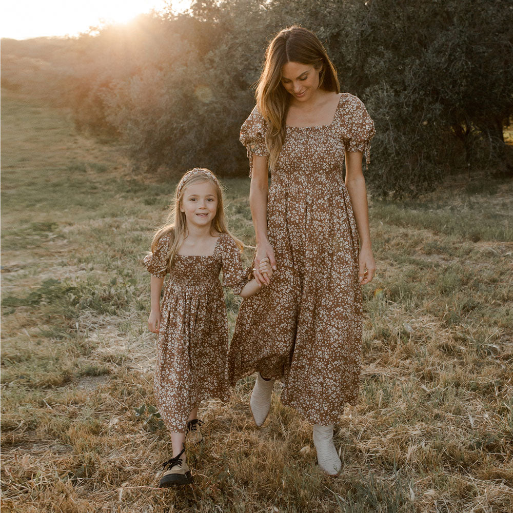 Little girl wearing Rylee and Cru Adelaide Dress - Harvest standing next to mom