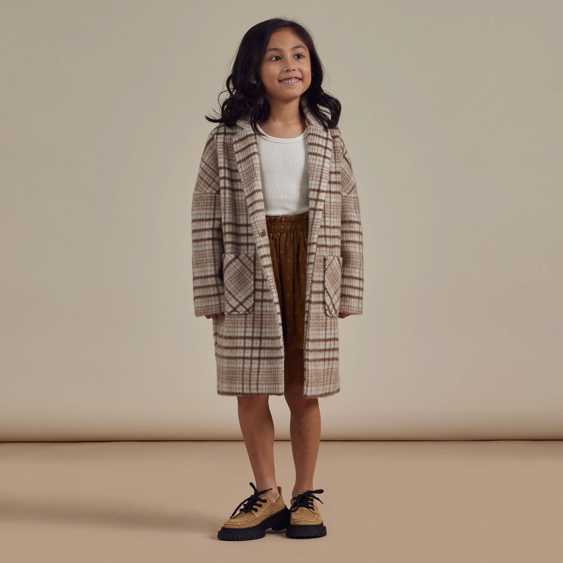 Girl wearing Rylee and Cru Longline Coat - Rustic Plaid - Brass / Natural