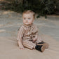 Baby wearing Rylee and Cru Rhett Jumpsuit - Cedar Pinstripe
