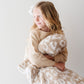 Little girl holding Saranoni Receiving Double-Layer Bamboni Blanket - Tan Leopard